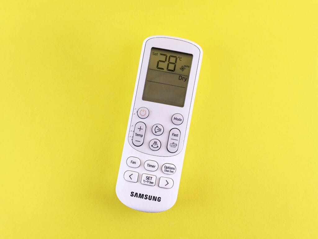 how do you know if you need a new thermostat or how can a smart thermostat keep the bills down in summer 55 Air conditioner remote with temperature set at 28°C on a yellow background.